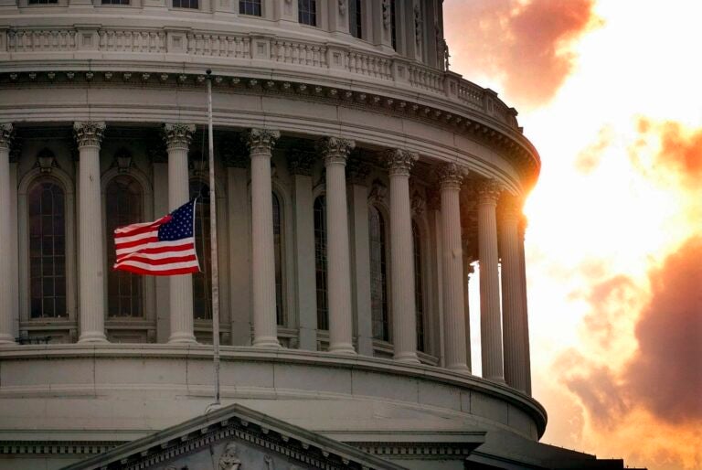 In this July 24, 1998, file photo, a flag flies at half-staff on Capitol Hill in honor of two Capitol police officers who were killed after a gunman burst through security barriers. (AP Photo/Doug Mills)