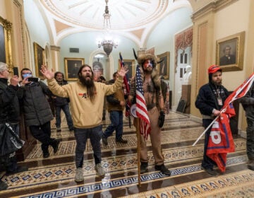 Pro-Trump insurrectionists are confronted by Capitol Police officers outside the Senate Chamber