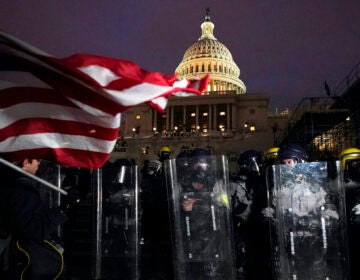 Police stand outside the Capitol after a day of rioting protesters, Wednesday, Jan. 6, 2021, at the Capitol in Washington. (AP Photo/Julio Cortez)