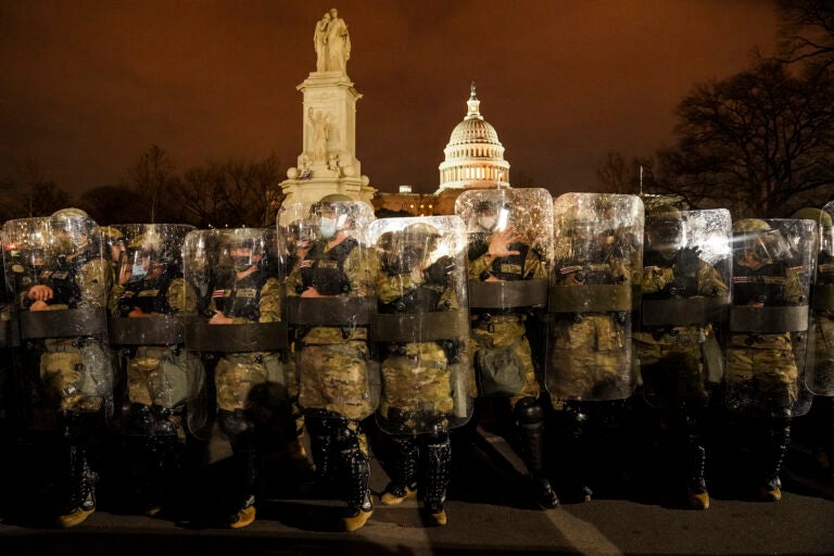 District of Columbia National Guard stand outside the Capitol, Wednesday night, Jan. 6, 2021, after a day of rioting protesters. It's been a stunning day as a number of lawmakers and then the mob of protesters tried to overturn America's presidential election, undercut the nation's democracy and keep Democrat Joe Biden from replacing Trump in the White House. (AP Photo/John Minchillo)