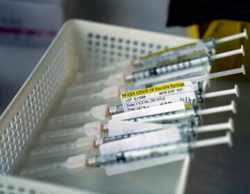 Syringes containing the Pfizer-BioNTech COVID-19 vaccine are seen in a vaccination room at St. Joseph Hospital in Orange, Calif. Thursday, Jan. 7, 2021. (AP Photo/Jae C. Hong)