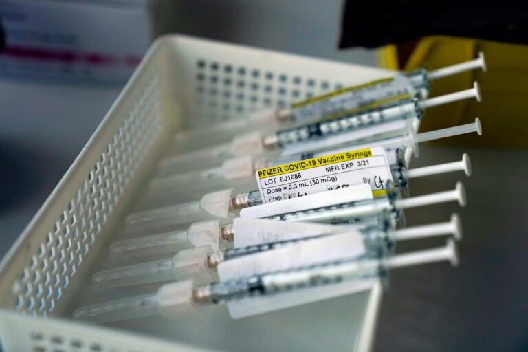 Syringes containing the Pfizer-BioNTech COVID-19 vaccine are seen in a vaccination room at St. Joseph Hospital in Orange, Calif. Thursday, Jan. 7, 2021. (AP Photo/Jae C. Hong)