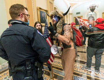 Supporter of President Donald Trump are confronted by Capitol Police officers outside the Senate Chamber inside the Capitol, Wednesday, Jan. 6, 2021 in Washington.  (AP Photo/Manuel Balce Ceneta)