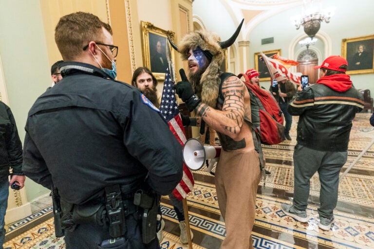 Supporter of President Donald Trump are confronted by Capitol Police officers outside the Senate Chamber inside the Capitol, Wednesday, Jan. 6, 2021 in Washington.  (AP Photo/Manuel Balce Ceneta)