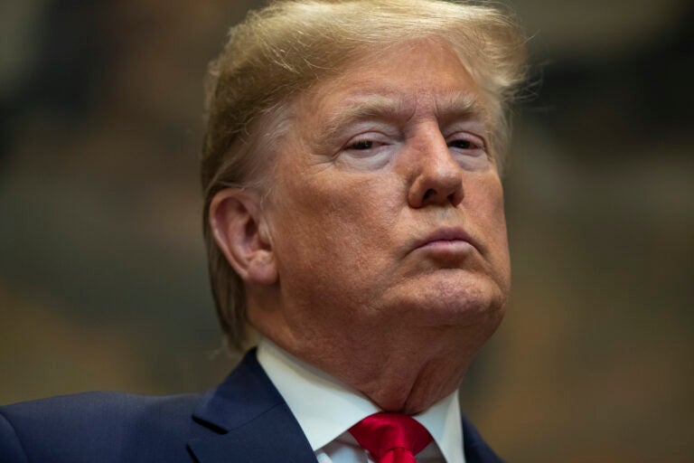 FILE - In this Jan. 9, 2020, file photo President Donald Trump listens as Secretary of the Interior David Bernhardt delivers remarks on proposed changes to the National Environmental Policy Act, at the White House in Washington. In Trump's presidency, fact checking became a cottage industry unto itself. And “alternative facts