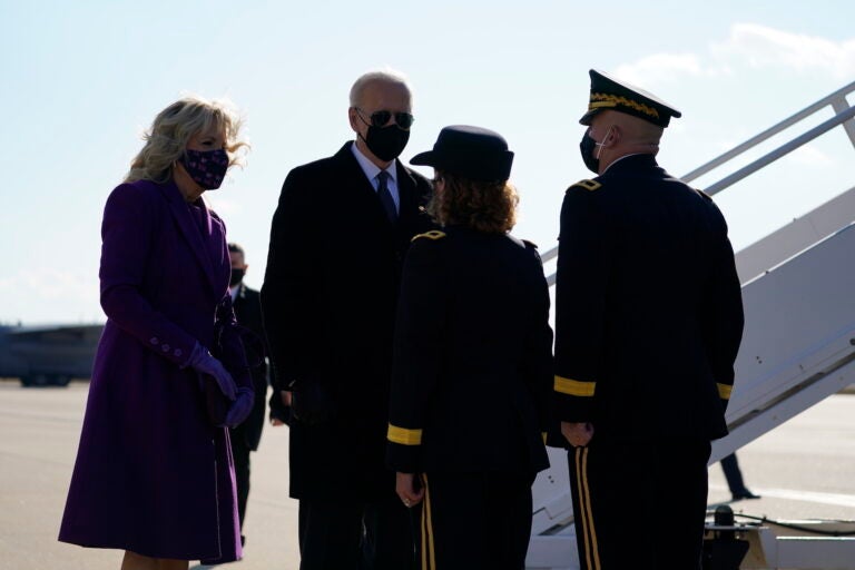 President-elect Joe Biden and his wife Jill Biden are greeted by Delaware Adjutant General Michael Berry and his wife Gen. Karen Berry before they board a plane at New Castle Airport, Tuesday, Jan. 19, 2021, in New Castle, Del. (AP Photo/Evan Vucci)