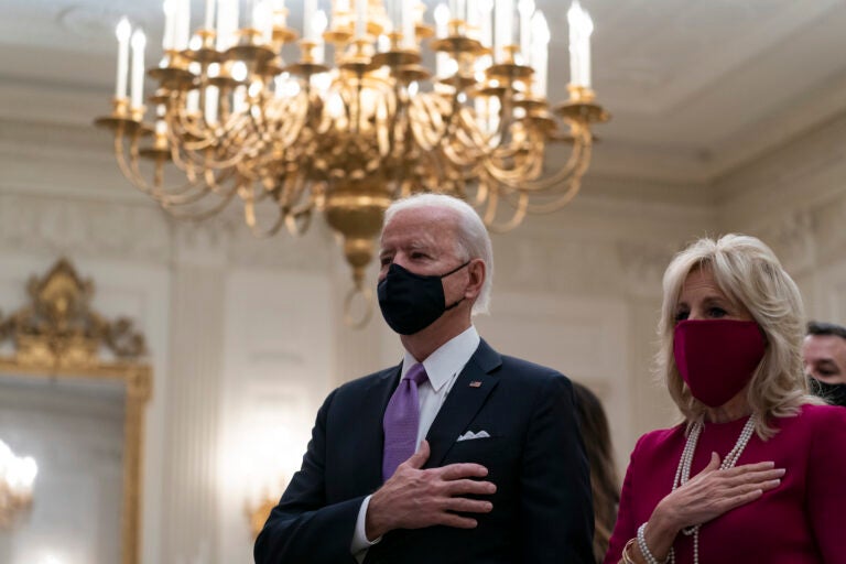 President Joe Biden, accompanied by first lady Jill Biden, places his hand over his heart during a performance of the national anthem, during a virtual Presidential Inaugural Prayer Service in the State Dinning Room of the White House, Thursday, Jan. 21, 2021, in Washington. (AP Photo/Alex Brandon)