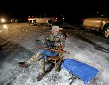 In this Jan. 5, 2016 file photo Arizona rancher LaVoy Finicum holds a gun as he guards the Malheur National Wildlife Refuge near Burns, Ore. (AP Photo/Rick Bowmer)