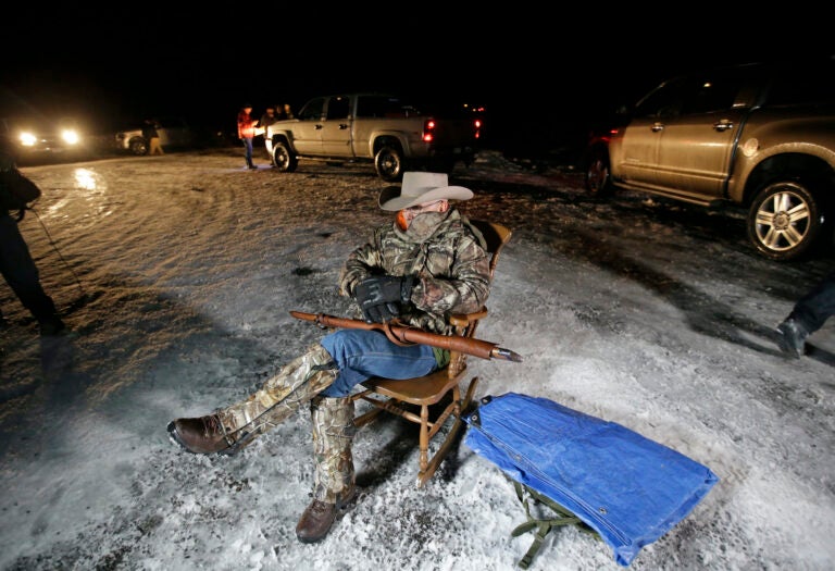 In this Jan. 5, 2016 file photo Arizona rancher LaVoy Finicum holds a gun as he guards the Malheur National Wildlife Refuge near Burns, Ore. (AP Photo/Rick Bowmer)