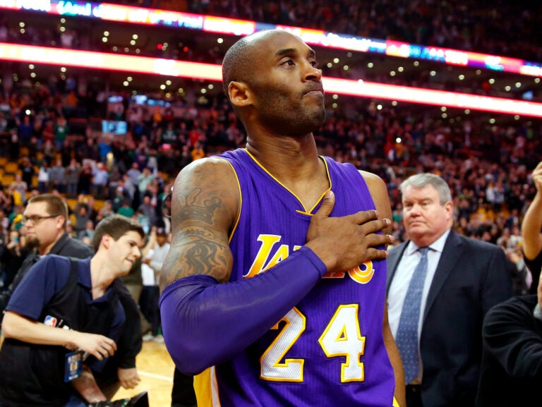 In this Dec. 30, 2015, file photo, Los Angeles Lakers' Kobe Bryant touches his chest as he walks off the court in Boston after the Lakers' 112-104 win over the Boston Celtics in an NBA basketball game. (AP Photo/Winslow Townson)