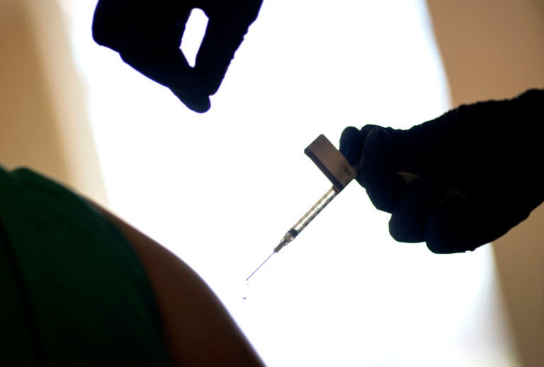 In this Tuesday, Dec. 15, 2020 file photo, a droplet falls from a syringe after a health care worker was injected with the Pfizer-BioNTech COVID-19 vaccine in Providence, R.I. (AP Photo/David Goldman)