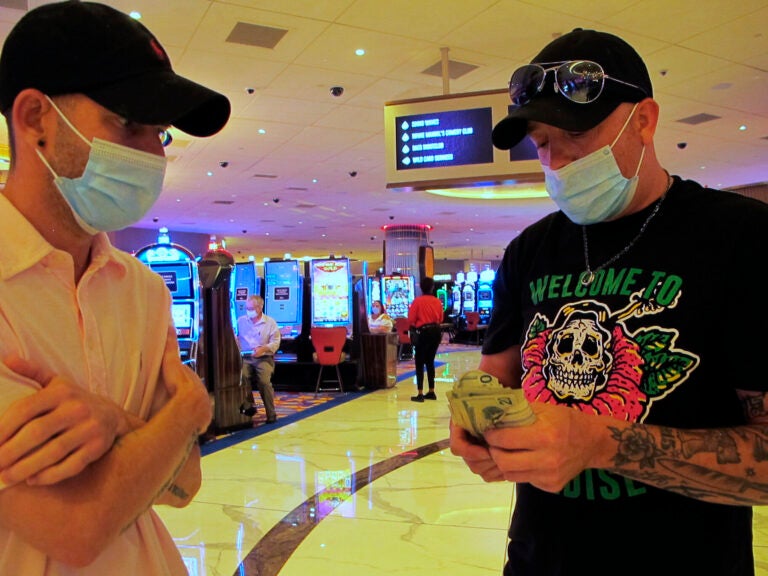 Gamblers count their money before starting to make bets at the Hard Rock casino in Atlantic City
