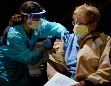 Helen Fitzpatrick, 97, right, receives a COVID-19 vaccine administered by Dr. Hillary Cohen at Englewood Health