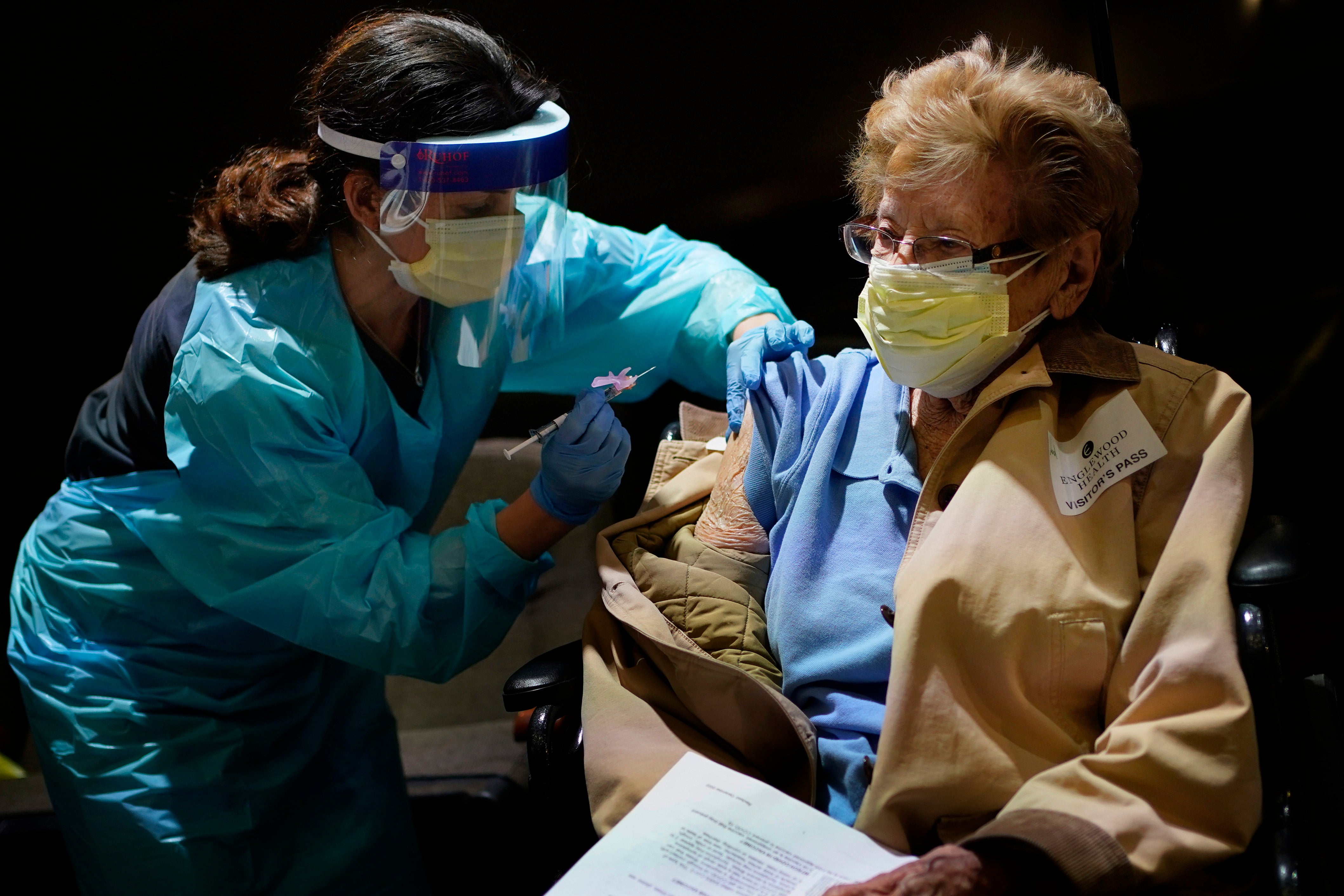 Helen Fitzpatrick, 97, right, receives a COVID-19 vaccine administered by Dr. Hillary Cohen at Englewood Health