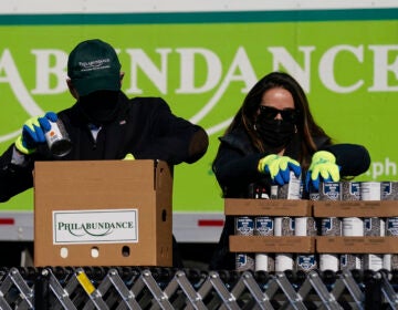 President-elect Joe Biden, left, participates in a National Day of Service event at Philabundance