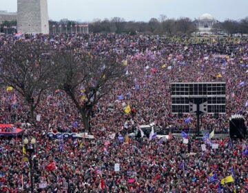 With the Washington Monument in the background, people attend a rally in support of President Donald Trump near the White House on Wednesday, Jan. 6, 2021, in Washington.