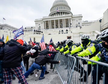 Trump supporters try to break through a police barrier at the U.S. Capitol