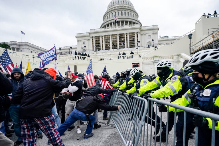 Trump supporters try to break through a police barrier at the U.S. Capitol