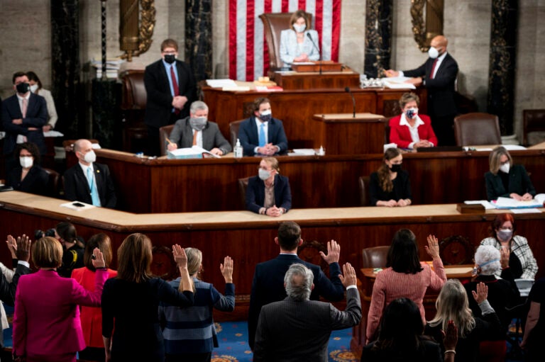 House Speaker Nancy Pelosi administers the oath of office to members of the 117th Congress