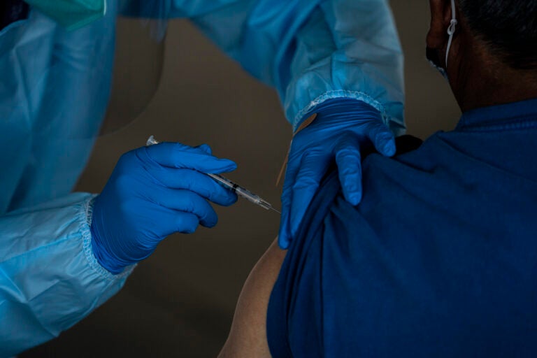 A person receives the Pfizer-BioNTech COVID-19 vaccine