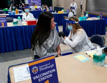 Tiffany Husak receives a COVID-19 vaccine at a vaccination clinic