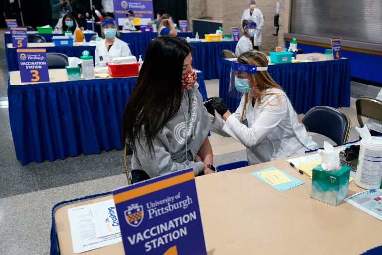 Tiffany Husak receives a COVID-19 vaccine at a vaccination clinic