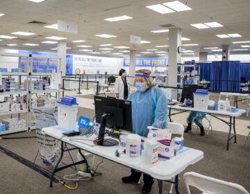 Health care workers prepare to give COVID-19 vaccinations at a former Sears store turned in to a vaccination site, in Rockaway, N.J.