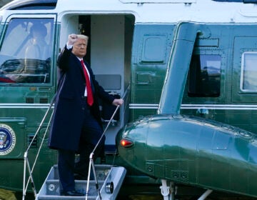 President Donald Trump gestures as he boards Marine One on the South Lawn of the White House