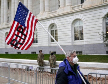 A protester walks past the Russell Senate Office Building on Capitol Hill
