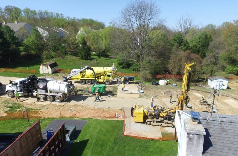 In this file photo, Mariner East 2 pipeline construction crews work in the backyards of homes on Lisa Drive in West Whiteland Township, Chester County, on May 2, 2018 after sinkholes opened in the area. That caused one of the ME2 project's many delays. (Marie Cusick / WITF)