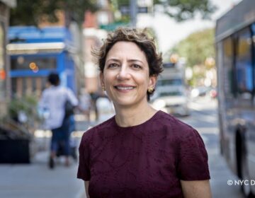 Polly Trottenberg stands outside on the street.