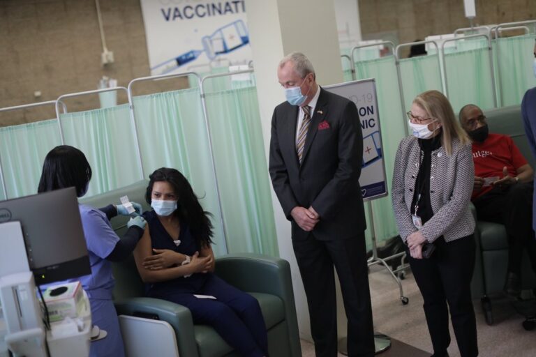 Gov. Murphy looks on as frontline health care workers at University Hospital in Newark received their second doses of the Pfizer-BioNTech vaccine.