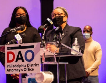 Myra Maxwell speaks at a podium with a sign stating the Philadelphia District Attorney's Office in front of her.