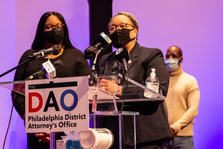 Myra Maxwell speaks at a podium with a sign stating the Philadelphia District Attorney's Office in front of her.