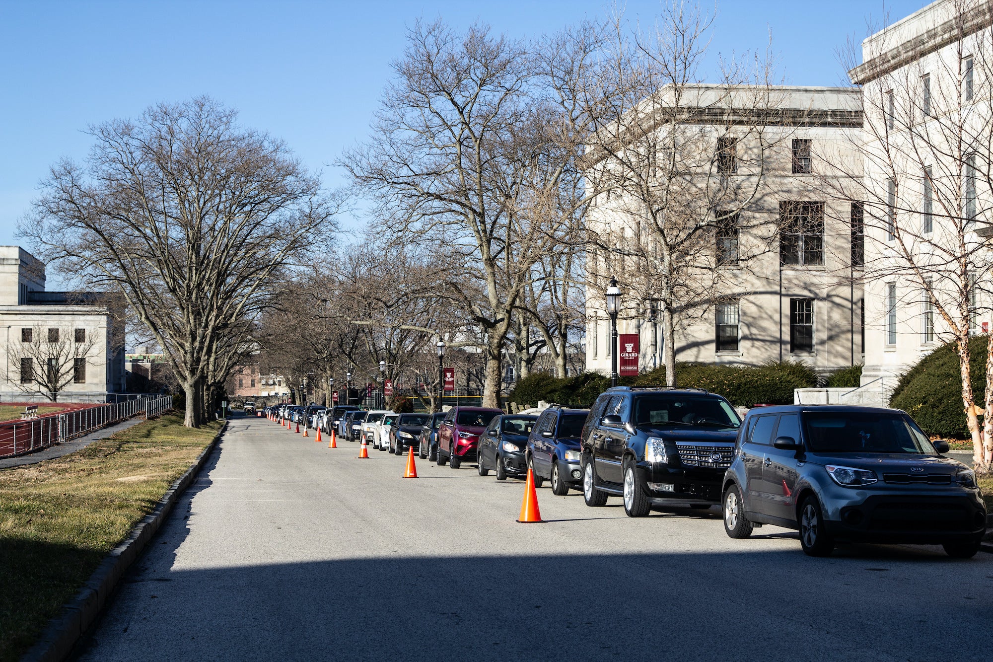 A long line of drivers wait for free COVID-19 testing at Girard College