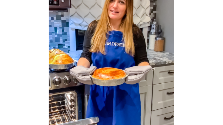 Culinary arts teacher Mrs. Mylonas shows a traditional Greek New Year's cake