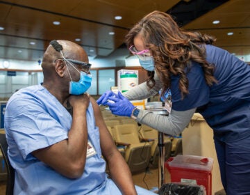 A Penn Medicine worker receives the Pfizer COVID-19 vaccine