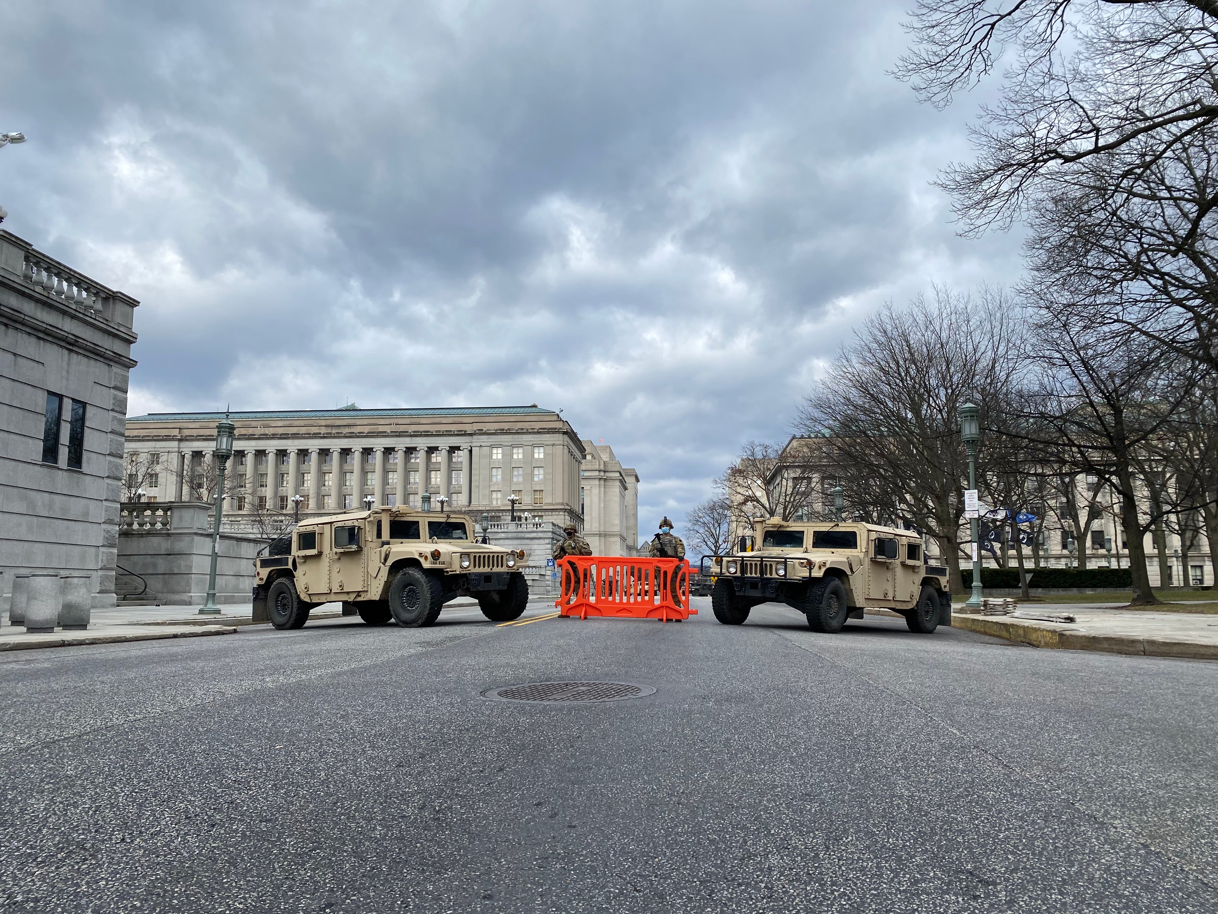 Two armored humvees are parked on a street near the Pa. state Capitol 