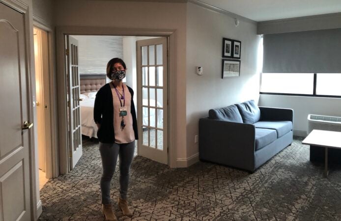 Eppehimer stands in one of the suites for use by families, which include a mother with seven children. (Cris Barrish/WHYY)