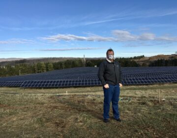 Cory Miller, executive director of the University Area Joint Authority, in the State College area of Centre County, standing in front of a UAJA solar panel project. (Anne Danahy / StateImpact Pennsylvania)