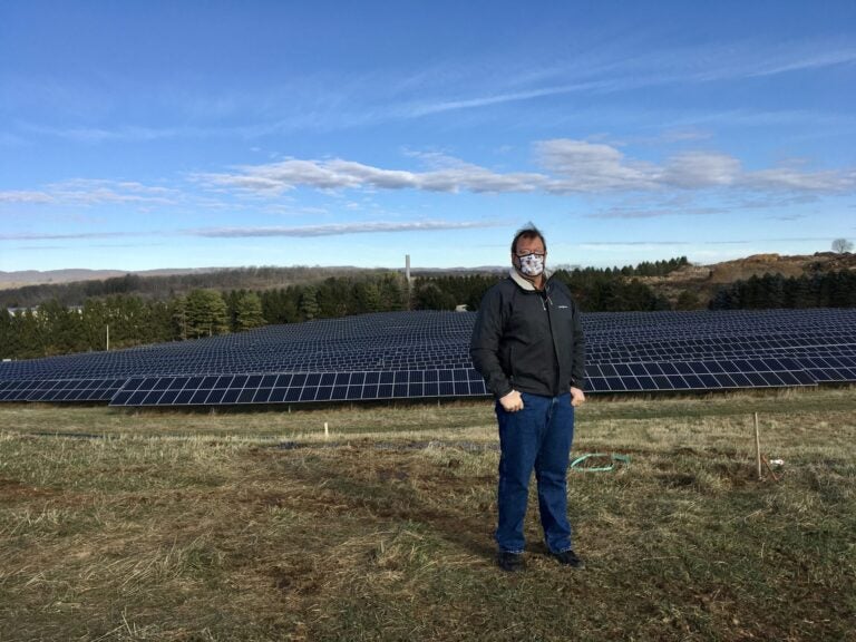 Cory Miller, executive director of the University Area Joint Authority, in the State College area of Centre County, standing in front of a UAJA solar panel project. (Anne Danahy / StateImpact Pennsylvania)