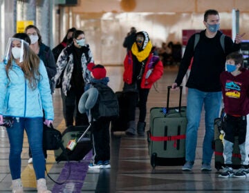 Travelers wear face masks in the main terminal of Denver International Airport