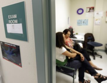 Two women wait in an exam room at Nuestra Clinica Del Valle