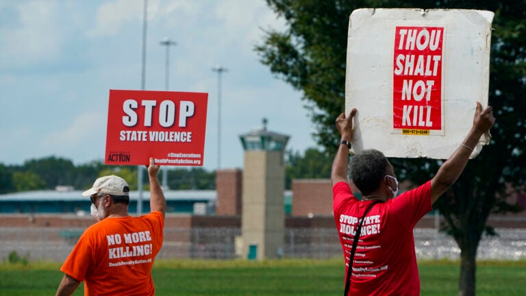 Protesters gather near the the federal prison complex in Terre Haute, Ind., on Aug. 28, 2020, ahead of the scheduled execution of Keith Dwayne Nelson, who was convicted of kidnapping, raping and murdering at 10-year-old Kansas girl. Democrats are pushing new legislation to outlaw federal executions. (Michael Conroy/AP)