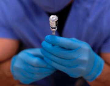A dose of Pfizer-BioNTech COVID-19 vaccine is prepared in a syringe before a second round of vaccinations were administered at Beaumont Health in Southfield, Mich., Tuesday, Jan. 5, 2021.