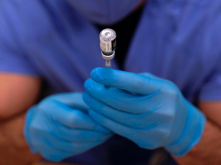 A dose of Pfizer-BioNTech COVID-19 vaccine is prepared in a syringe before a second round of vaccinations were administered at Beaumont Health in Southfield, Mich., Tuesday, Jan. 5, 2021.