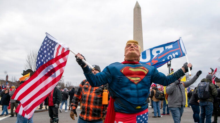 With the Washington Monument in the background, people attend a rally in support of President Donald Trump