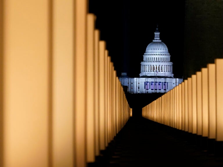 Lights surround the Lincoln Memorial Reflecting Pool, placed as a memorial to COVID-19 victims