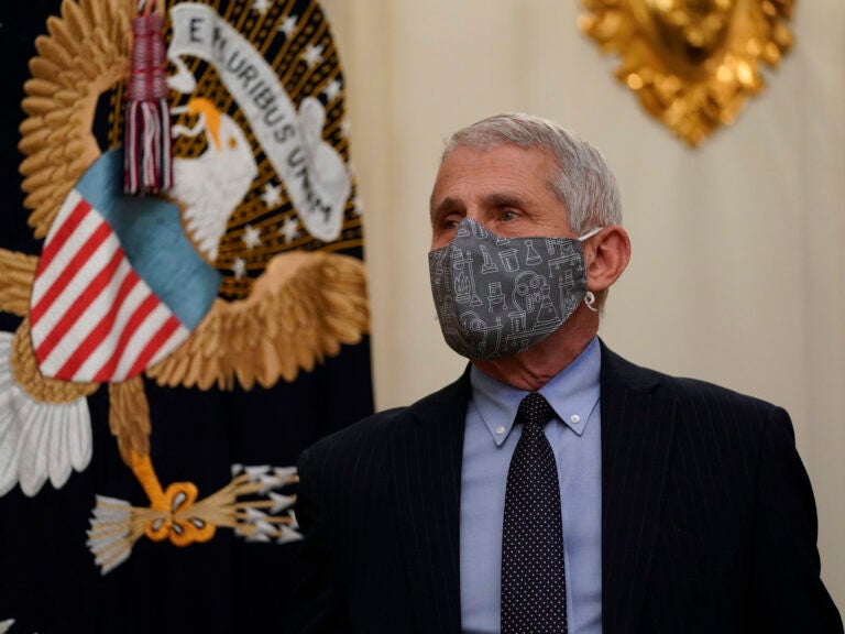 Dr. Anthony Fauci wears a face mask inside the State Dining Room of the White House