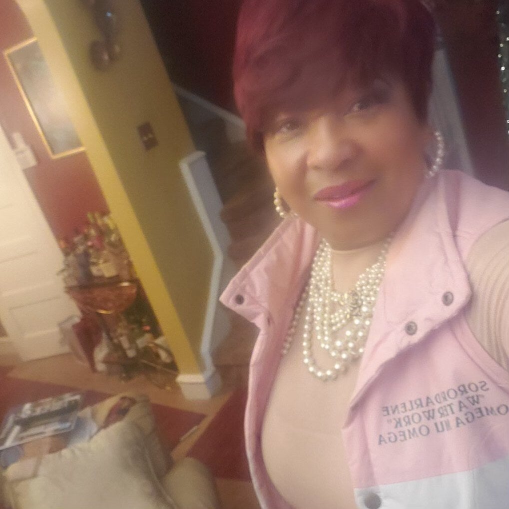 Darlene Miller wears an AKA vest and pearls inside her home